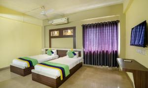 Itsy Hotels Vijaya Residency客房内的一张或多张床位