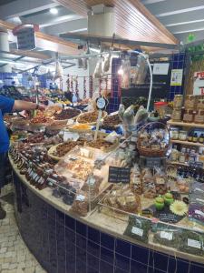 a woman standing in front of a display case in a bakery at Casa Eleonora b&b in Lagos