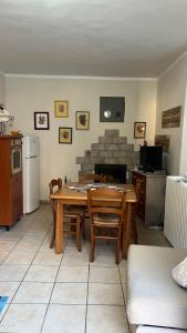 a living room with a table and a fireplace at La betulla in Perrero