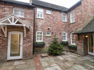 a brick house with a christmas tree in front of it at Dovedale in Ashbourne