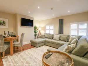 ein Wohnzimmer mit einem Sofa und einem Tisch in der Unterkunft Monsal Dale in Ashbourne