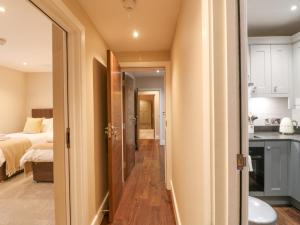 a hallway leading to a bedroom with a bed at Monsal Dale in Ashbourne