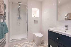 a bathroom with a shower and a toilet and a sink at The Terrace At Westbrook - Pet friendly in Margate