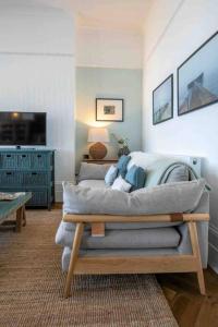a living room with a couch and a tv at The Terrace At Westbrook - Pet friendly in Margate