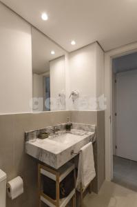 a bathroom with a sink and a large mirror at Distinguished And Elegant Apartment 2 Bedroom in Asuncion