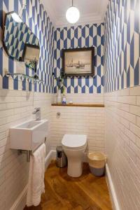 a bathroom with a sink and a toilet at The Coves in Margate