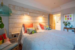 a bedroom with a large bed with a wooden headboard at The Coves in Margate