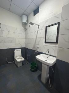 a bathroom with a sink and a toilet at Bachan Niwas Hotel in Jodhpur