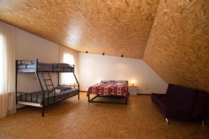 a attic room with two bunk beds and a couch at Saniba Gudauri in Gudauri