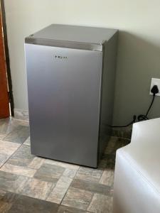 a refrigerator sitting in the corner of a room at Orlando Manor in Soweto