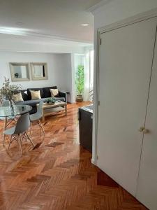 sala de estar con sofá y mesa en Apartamento con terraza y vistas AlcaláRetiro en Madrid