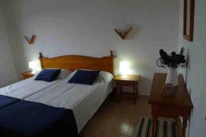 Turqueta - Apartamento con piscina junto la playa في كالا إن بلانيس: غرفة نوم بسرير من اللون الازرق والابيض +26 صورة