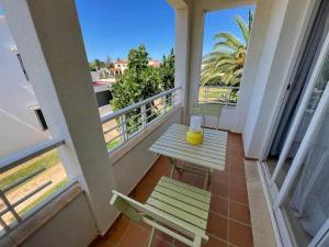 卡拉恩布拉內斯的住宿－Macarella Apatamento con piscina，阳台配有桌子,享有海景。