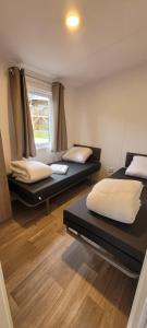 a room with two beds and a window at Goorzicht in Aalten