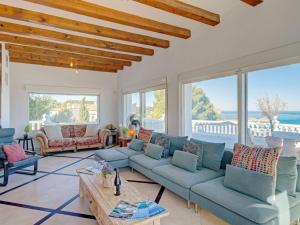 a living room with blue couches and a table at Villa Batavia by Interhome in Balcon del Mar