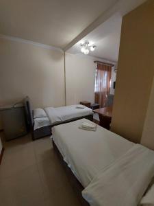 Voodi või voodid majutusasutuse Home Hotel toas
