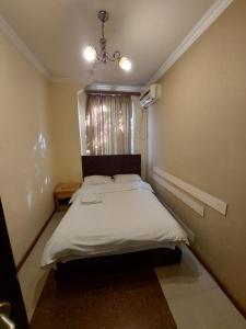 Voodi või voodid majutusasutuse Home Hotel toas