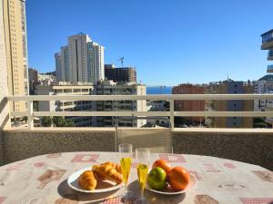 una mesa con 2 platos de comida en el balcón en Apartment Agua Viva by Interhome, en Cala de Finestrat