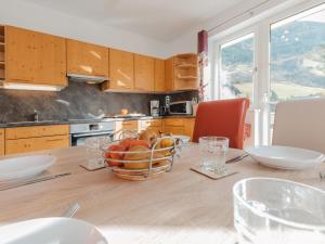 a kitchen with a table with a bowl of fruit on it at Apartment Stefanie Top 6 by Interhome in Bad Hofgastein