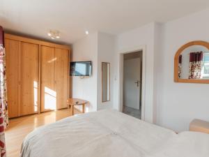 a bedroom with a bed and a tv on a wall at Apartment Stefanie Top 6 by Interhome in Bad Hofgastein