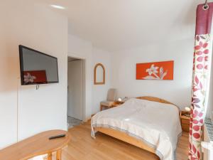 a bedroom with a bed and a flat screen tv at Apartment Stefanie Top 6 by Interhome in Bad Hofgastein