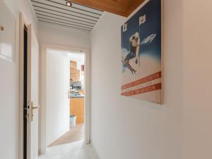 a hallway with a poster of a dog on the wall at Apartment Stefanie Top 6 by Interhome in Bad Hofgastein +36 photos