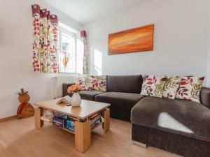 a living room with a couch and a table at Apartment Stefanie Top 6 by Interhome in Bad Hofgastein