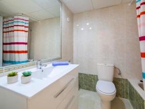 a bathroom with a toilet and a sink and a mirror at Apartment Zafiro 03 by Interhome in Calpe