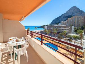 a balcony with a table and chairs and a view of the beach at Apartment Zafiro 03 by Interhome in Calpe