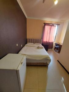 Voodi või voodid majutusasutuse Home Hotel toas
