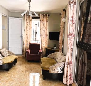 a living room with a couch and a chair at Apartment Huz Peer 3 in Trou aux Biches