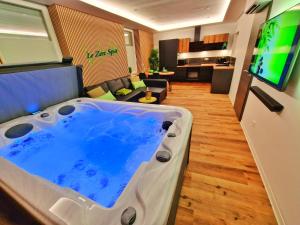 a room with a tub in the middle of a living room at -Le Zen Spa+Jacuzzi+Parking+Clim in Colmar