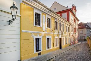 a yellow building on the side of a street at Spa Beerland Chateaux – U Zlaté Hrušky / At Golden pear in Prague