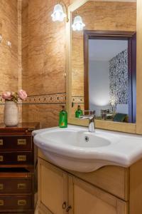 a bathroom with a sink and a mirror at LU Apartment Eur in Rome