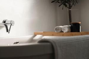 a bathroom with a sink and towels on a shelf at Renovated 3 Bedroom House in Lowton Pennington in Leigh