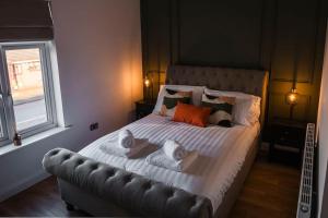 a bedroom with a large bed with towels on it at Renovated 3 Bedroom House in Lowton Pennington in Leigh