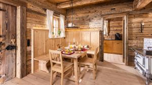 a wooden dining room with a table and chairs at Schrofen Chalets in Jungholz