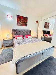 a bedroom with a large bed with red pillows at Pure Luxury Residence in Timişoara