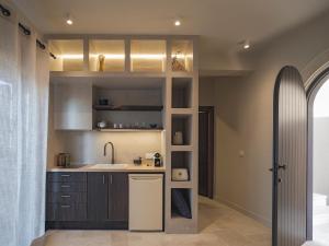 a kitchen with a sink and a counter top at Askianos Luxury Villas - An Oasis of Harmony & Elegance in Lístaros