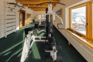 a gym with tread machines in a room with a window at Korunka in Tatariv