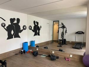 a room with a gym with dumbbells on the wall at Camelia 8 in Alanya