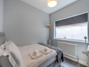 a bedroom with a bed and a large window at Victorian Suites Apartment in Southport