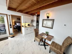 a kitchen and dining room with a table and chairs at Private Oceanfront Cabin With Hot Tub Doc Holiday Cabin in Ucluelet