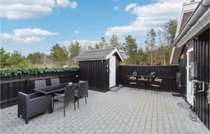 a patio with a table and chairs and a fence at Lovely Home In Strandby With Wifi in Strandby