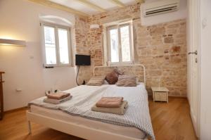 Posteľ alebo postele v izbe v ubytovaní Apartments Lavanda and Oliva
