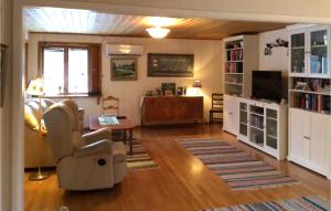 Awesome Home In Norrtlje With Wifi في نورتليه: غرفة معيشة مع أريكة وتلفزيون