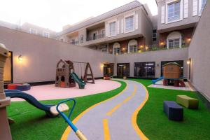 a playground in a building with a slide at Nuzul R154 - Elegant Apartment in Riyadh