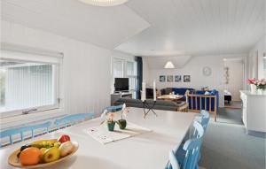 a room with a table with a bowl of fruit on it at Awesome Home In Blvand With 3 Bedrooms, Wifi And Sauna in Blåvand
