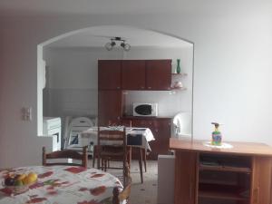 a kitchen with a table and a dining room at Gîte sur l'estuaire de la Gironde in Saint-Seurin-dʼUzet