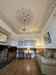 a living room with a couch and a chandelier at Watermead House in Chard